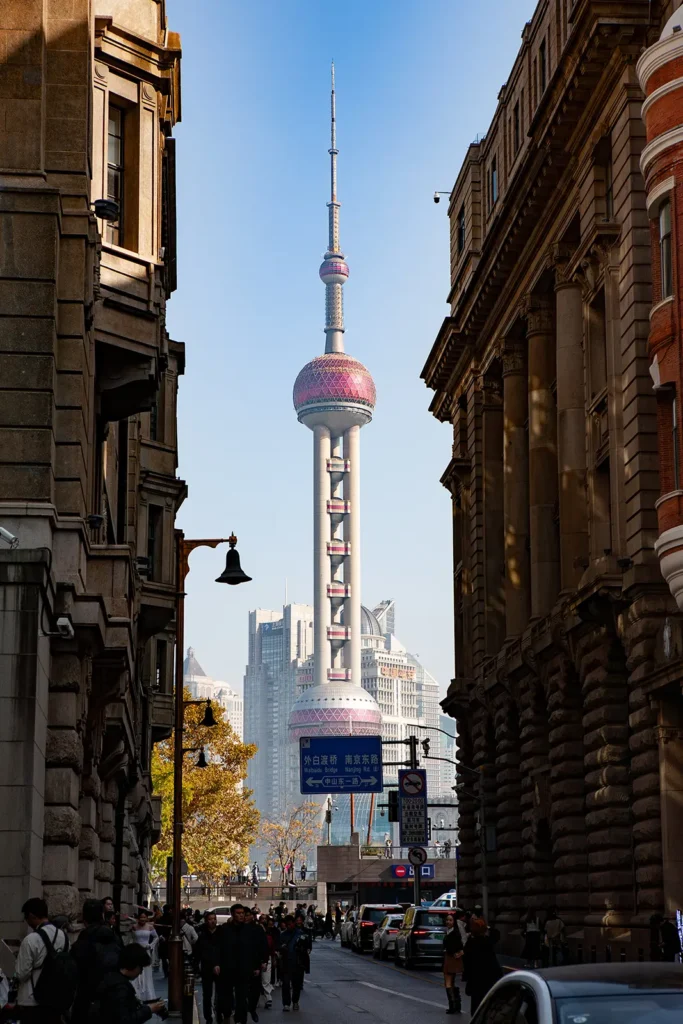 Oriental Pearl Tower viewed from the Bund, framed by historic colonial buildings on Zhongshan Road