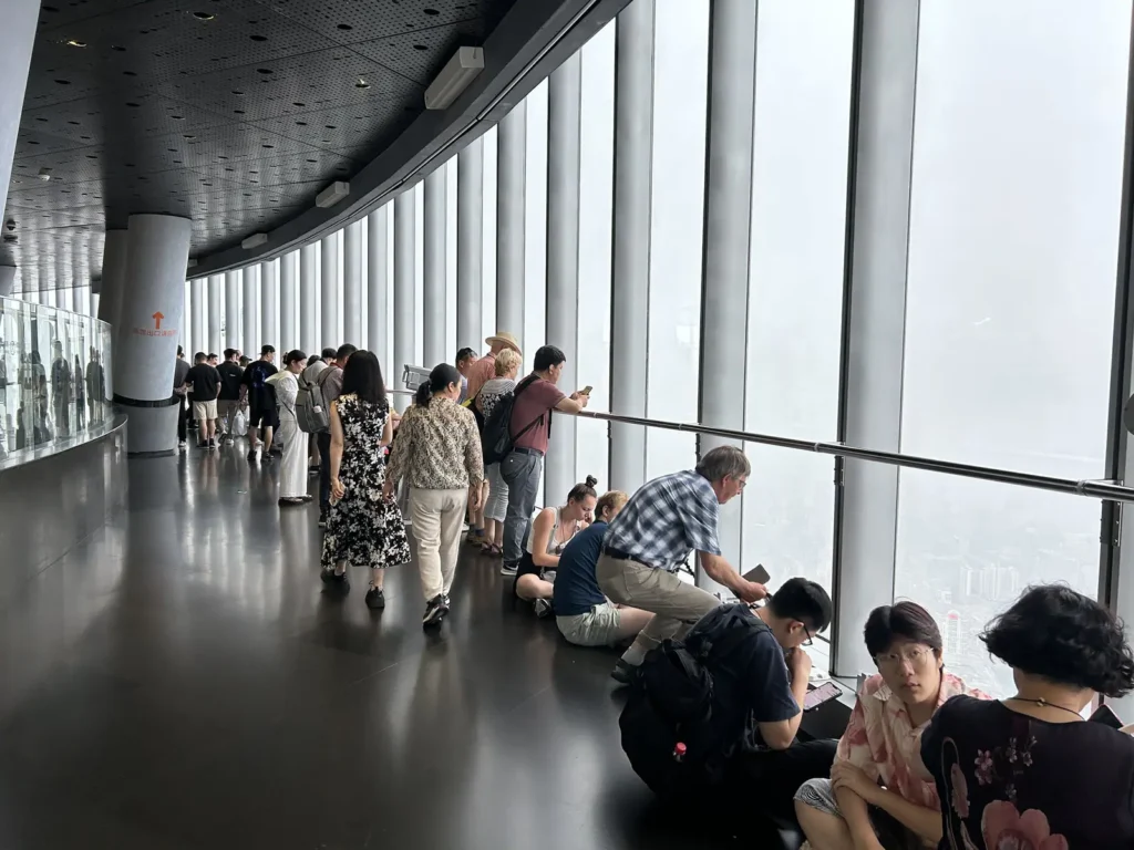 Visitors looking out at the view from the Shanghai Tower observation deck