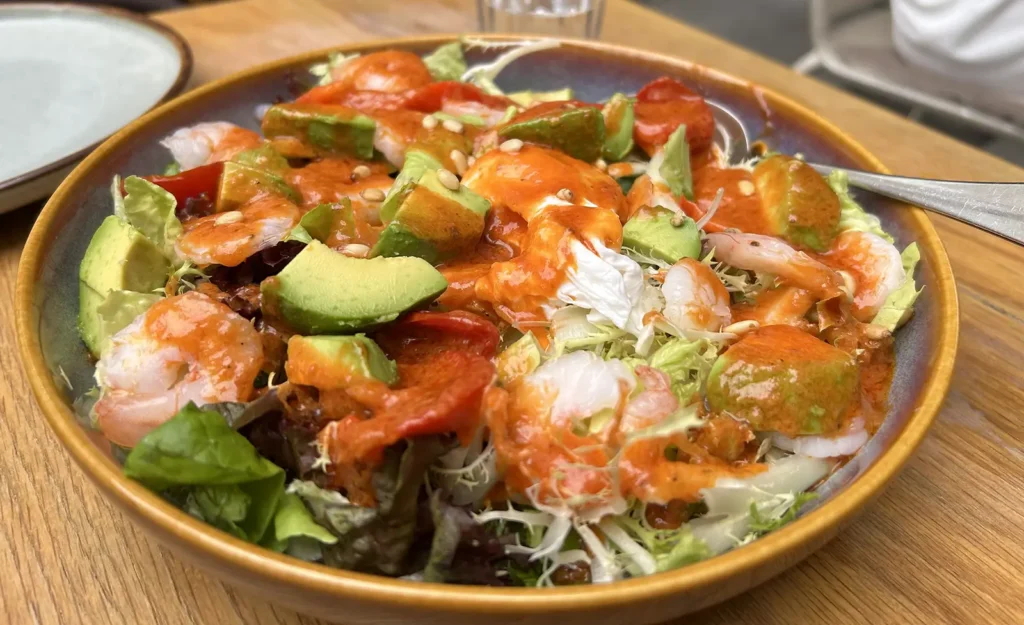 RAC Coffee Shanghai prawn and avocado salad with poached egg, tomato dressing and pine nuts