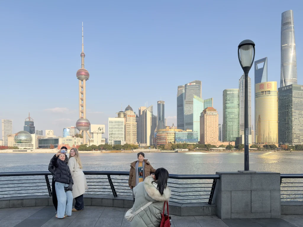 Tourists taking selfies at the Bund, a great spot for your Shanghai layover itinerary