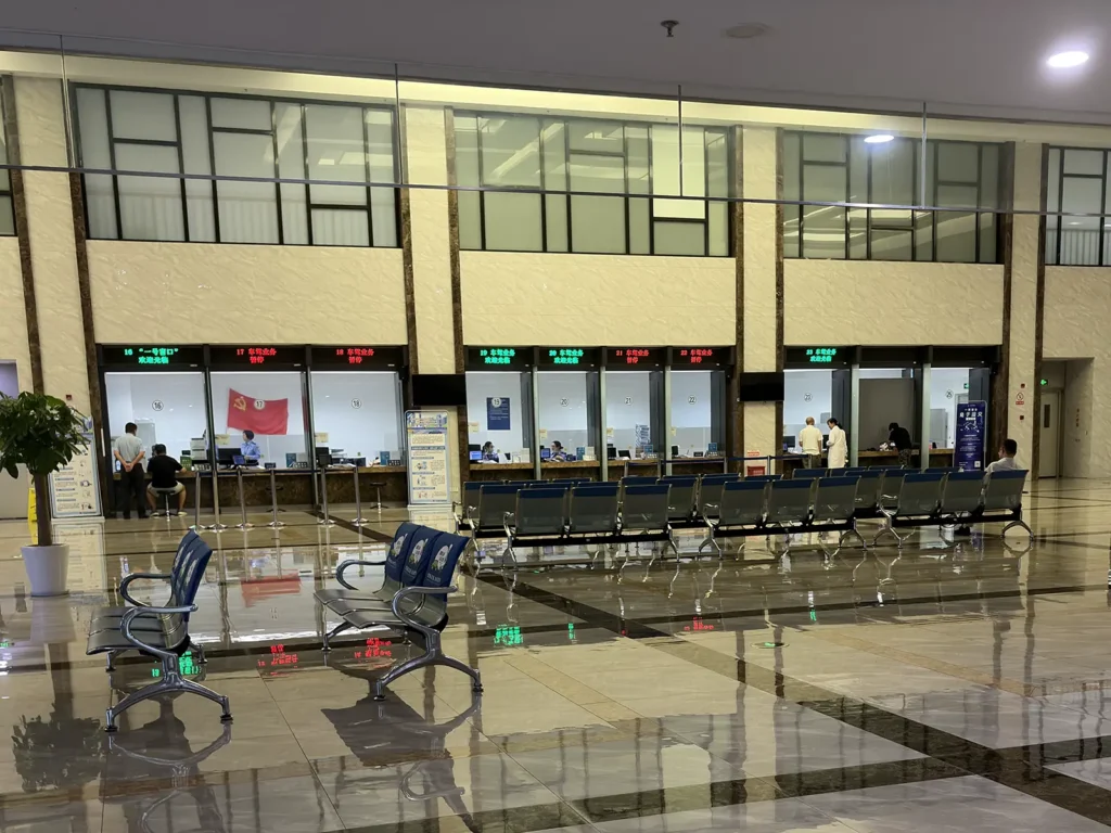 Waiting area and service counters inside Shanghai Vehicle Management Office Branch No. 1, where foreign visitors can apply for a temporary driving permit.